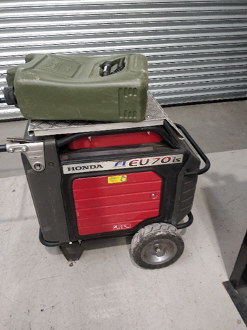 A gasoline can on top of a portable generator

Description automatically generated with medium confidence