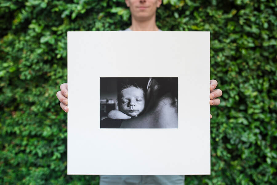 A person holding a picture of a baby

Description automatically generated with medium confidence